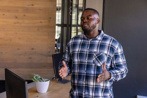 Confident Professional Giving Presentation in Modern Office