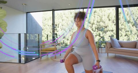Woman performing dumbbell lunge in sunlit living room with smartwatch and neon trails