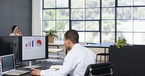 Professional Business Team Analyzing Data in Modern Workspace