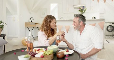 Mature couple enjoying wine and quality time at home