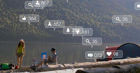 Couple camping by mountain lake with social notification bubbles over serene landscape