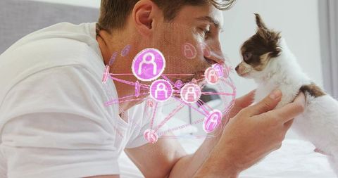 Man connecting with puppy through holographic network in bedroom