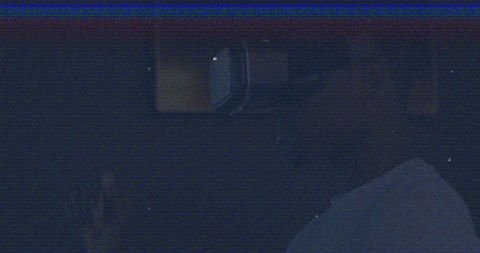 Man engaged in virtual reality experience in dark setting