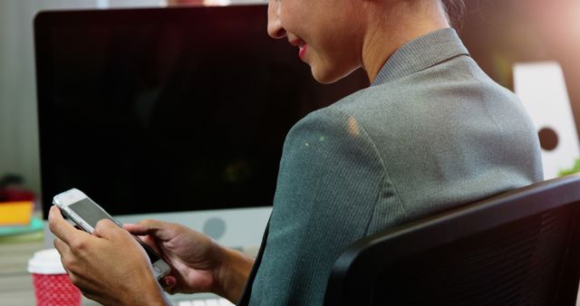 Businesswoman Using Smartphone in Office Workspace - Download Free Stock Images Pikwizard.com