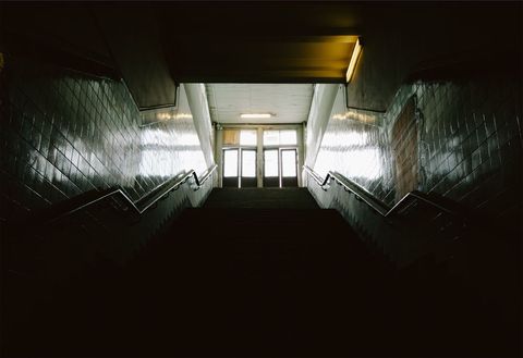 Moody Underground Staircase Leading to Lighted Doorway