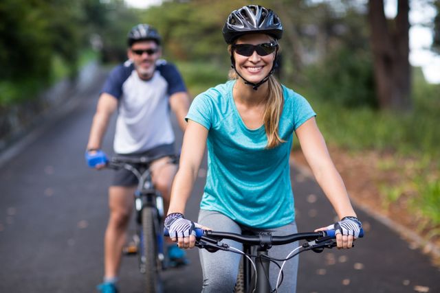 Smiling Couple Cycling on Open Road on Summer Day - Download Free Stock Photos Pikwizard.com