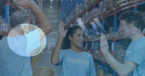 Volunteers Celebrating in Warehouse with Financial Graphics Overlay - Download Free Stock Images Pikwizard.com