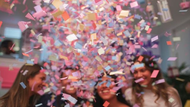 Joyful Celebration with Friends Amidst Falling Confetti