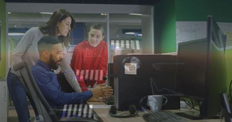 Collaborative team connecting network cable while analyzing real-time data visualizations