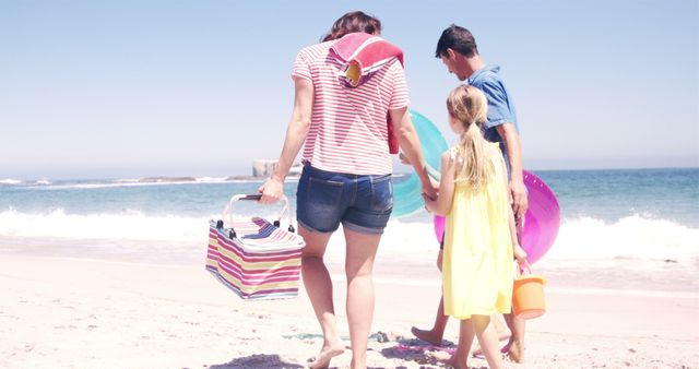 Family Enjoying Sunny Day on Beach, Carrying Picnic Items - Download Free Stock Images Pikwizard.com