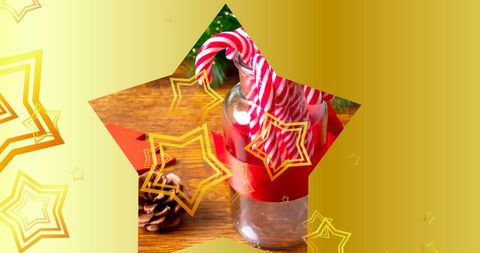 Festive candy canes in glass jar with golden stars overlay