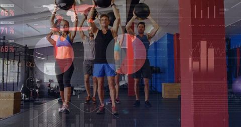 Group lifting medicine balls overhead during functional fitness circuit with digital data overlay