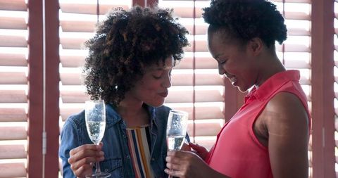 Joyful Diverse Couple Celebrating Together with Champagne Glasses