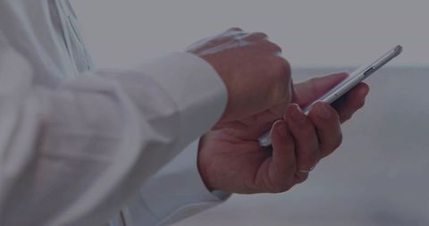 Senior professional using smartphone for communication