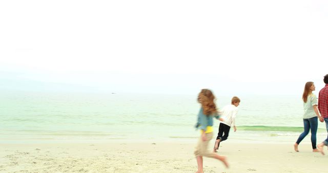Parents walking while children play on the beach
