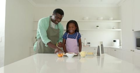 Father and Daughter Preparing Meal Together in Modern Kitchen