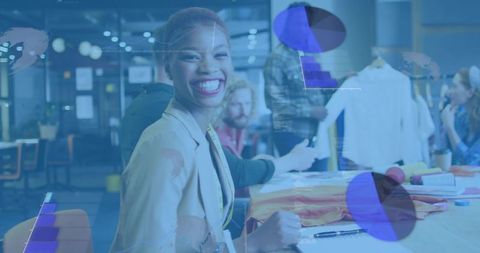 Smiling fashion designer leading collaborative team in textile studio with swatches