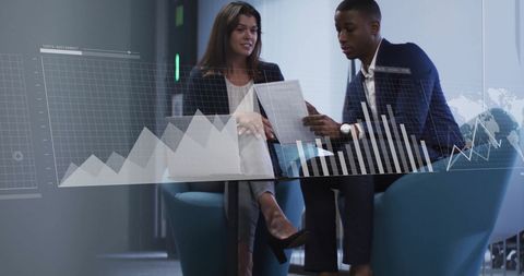 Multiracial Business Colleagues Analyzing Financial Charts in Modern Office