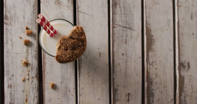 Glass of Milk with Two Straws and a Half-Eaten Cookie on Rustic Wooden Surface - Download Free Stock Images Pikwizard.com