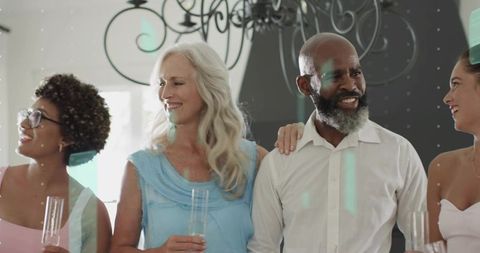 Multigenerational guests raising champagne flutes at elegant indoor celebration and toast