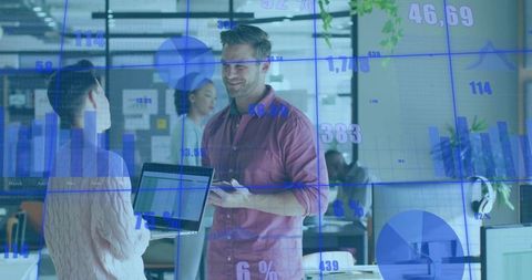 Collaborating over data analytics using tablet and laptop in modern open office workspace