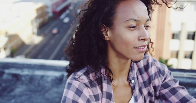 Thoughtful Woman in Casual Clothing on Urban Rooftop - Download Free Stock Images Pikwizard.com