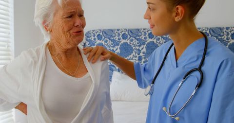 Doctor Consoling Senior Woman in Home Setting