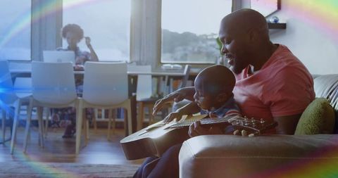 Father Teaching Son to Play Guitar at Home in Cozy Family Setting