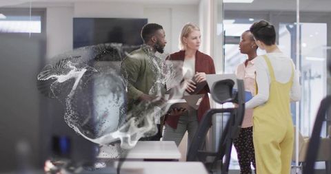 Professionals Collaborating Near Digital Particle Display in Modern Office