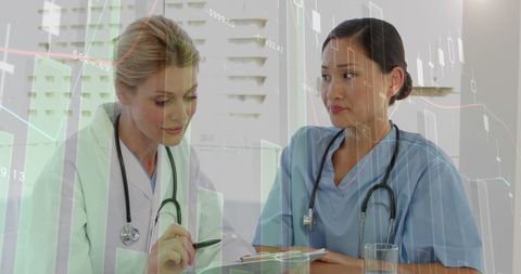 Female Doctors Analyzing Medical Data with Digital Interface