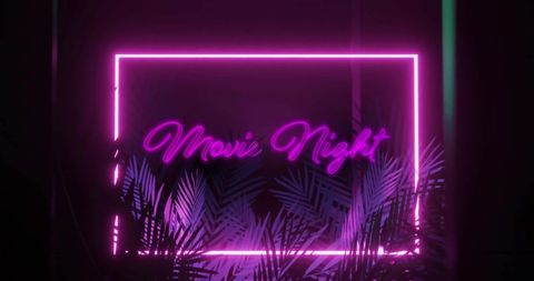 Neon movie night sign with purple hues and tropical leaves