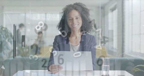 Confident Businesswoman Analyzing Data in Modern Office