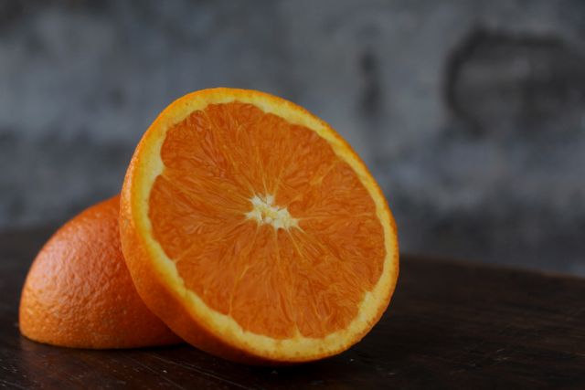 Close-Up of Fresh Orange Slices with Rustic Background - Download Free Stock Photos Pikwizard.com