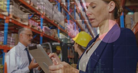 Businesswoman Analyzing Data While Managing Warehouse Stock - Download Free Stock Images Pikwizard.com