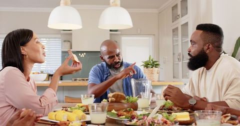Friends Sharing a Meal in Bright Modern Kitchen