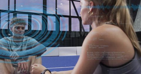 Coach guiding athlete breathing with ar hud overlay on blue mat during gym training
