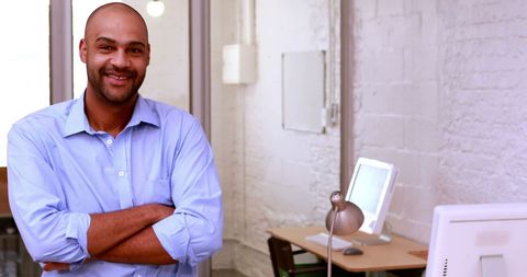 Confident casual businessman smiling in modern office