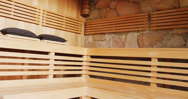 Wooden sauna room with benches merges traditional design with modern comfort. Ideal for use in health and wellness blogs, spa advertisements, and relaxation-themed content.