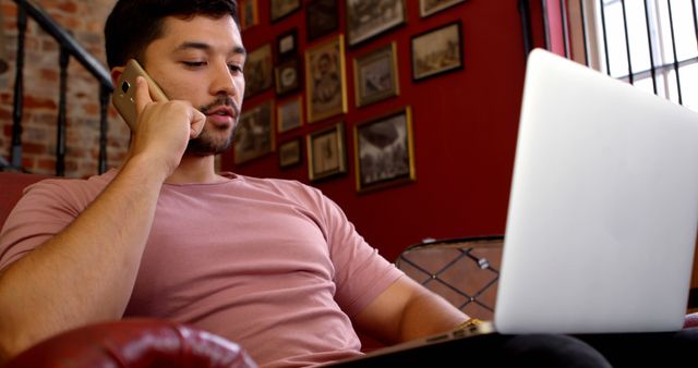 Young Man Working from Home While Talking on Phone - Download Free Stock Images Pikwizard.com