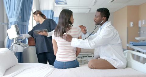 Doctor Conducting Check-Up on Female Patient in Modern Hospital