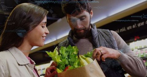 Couple analyzing groceries with fresh produce in supermarket aisle