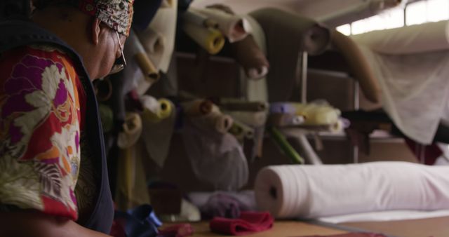 Tailor Working in Fabric Store Surrounded by Textile Rolls - Download Free Stock Images Pikwizard.com