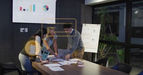 Team Collaborating on Business Strategy with Analytics in Office