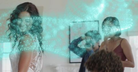 Bride smiling in lace gown while photographer capturing candid moment with teal particles