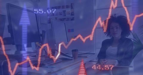 Businesswoman Monitoring Stock Charts in Open Office Space for Financial Analysis