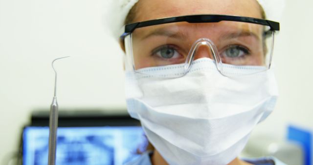 Female Dentist Holding Dental Tool in Modern Clinic - Download Free Stock Images Pikwizard.com