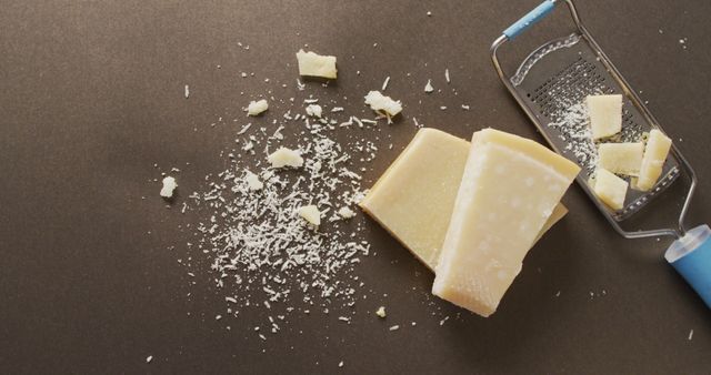 Grated Parmesan Cheese with Block and Grater on Dark Surface - Download Free Stock Images Pikwizard.com