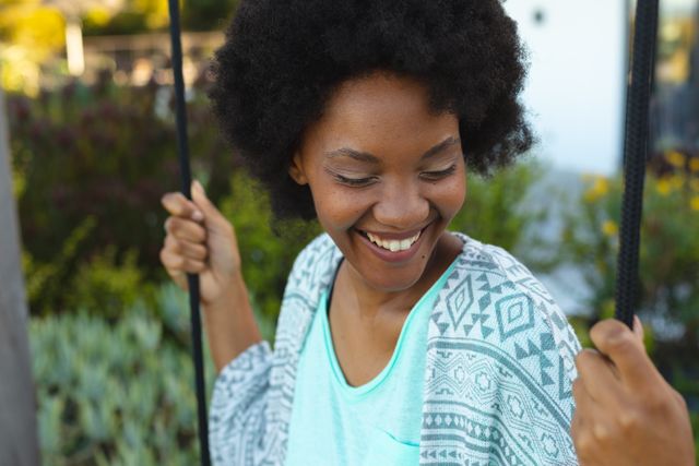 Close-up of smiling young afro african american woman enjoying at park, copy space. Unaltered, lifestyle and simple living concept.