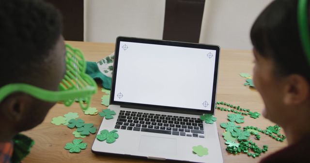 Friends with St. Patrick's Day Decorations Watching Video on Laptop - Download Free Stock Images Pikwizard.com