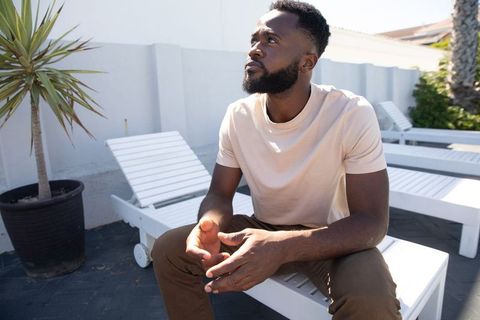 Relaxed Man on Patio Lounge Chair Looking Upward in Peaceful Outdoors